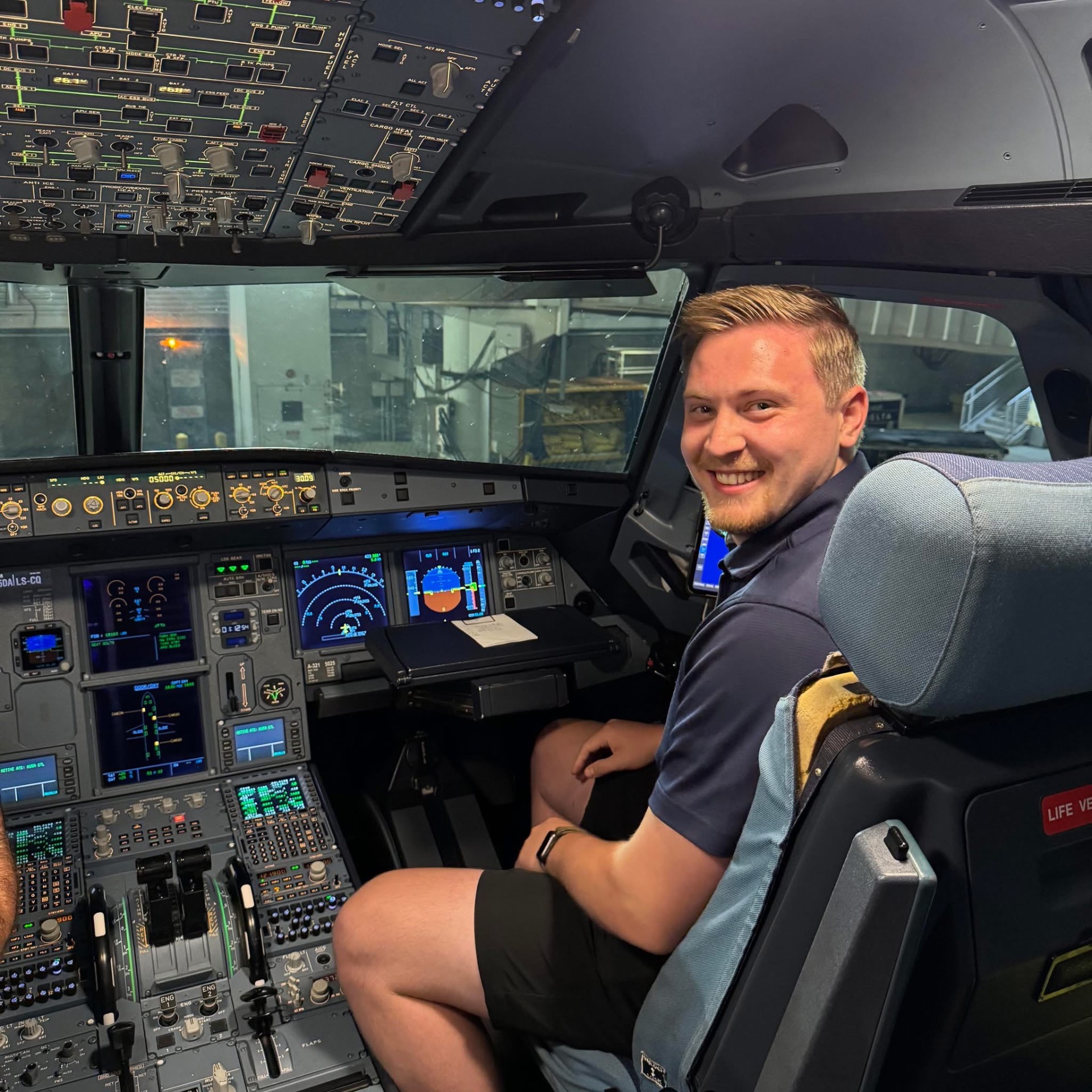 Future aviator in the cockpit of an A321 flight simulator