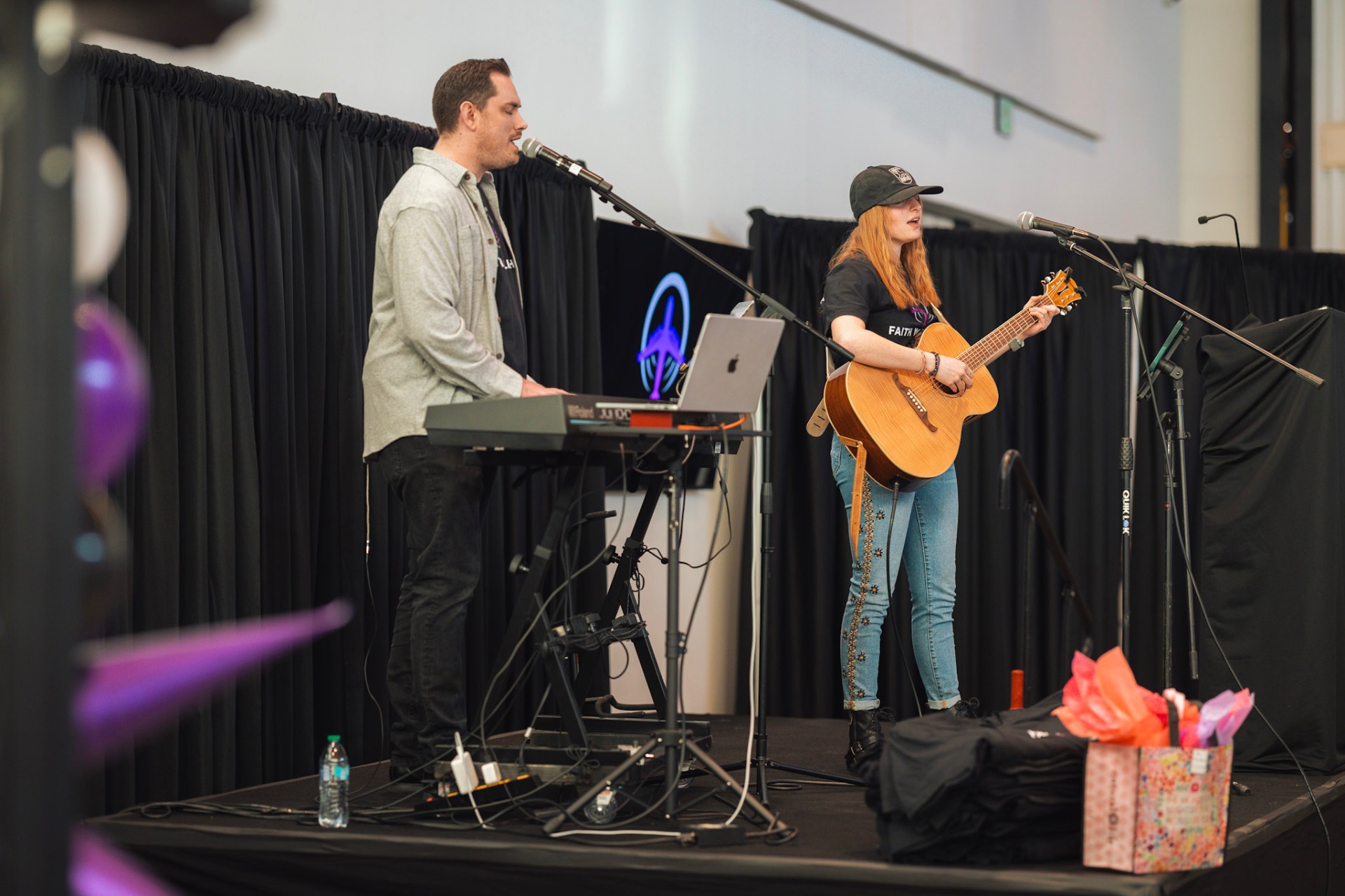 Worship team performing on stage at a Faith In Flight event