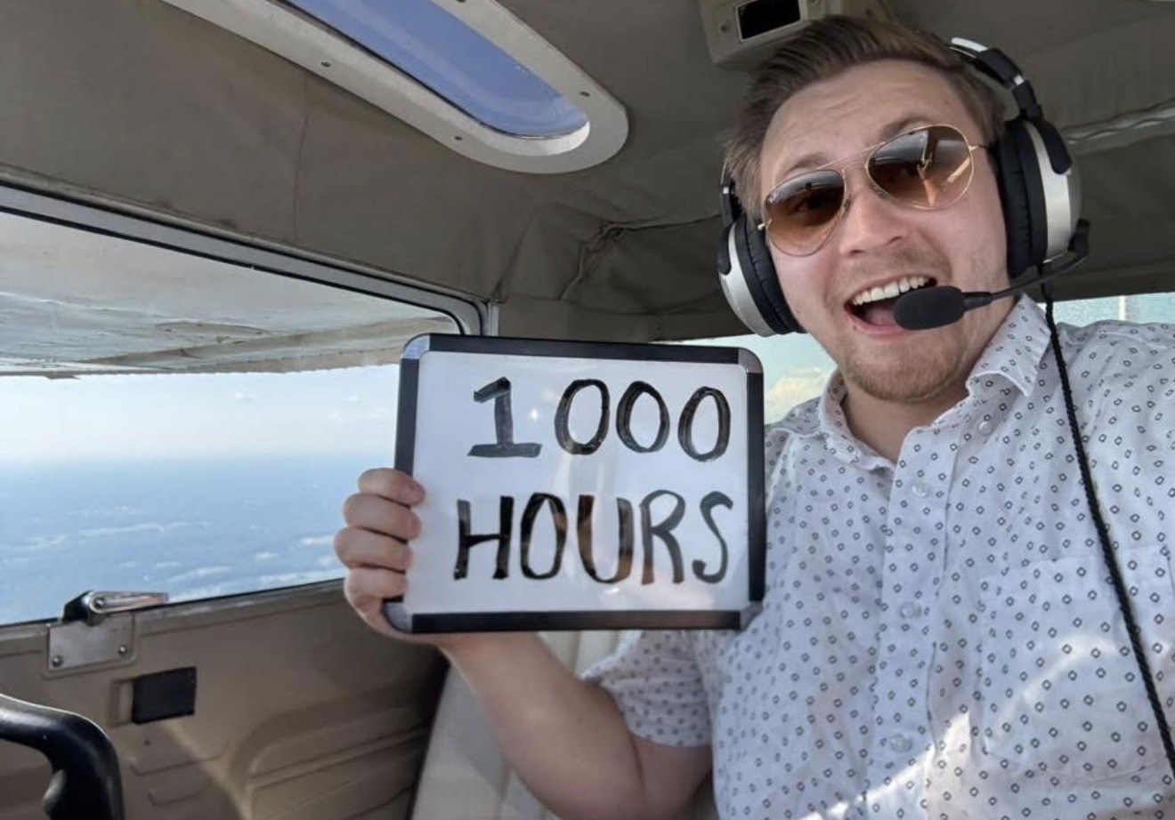 Pilot celebrating 1000 flight hours mid-flight in a small aircraft