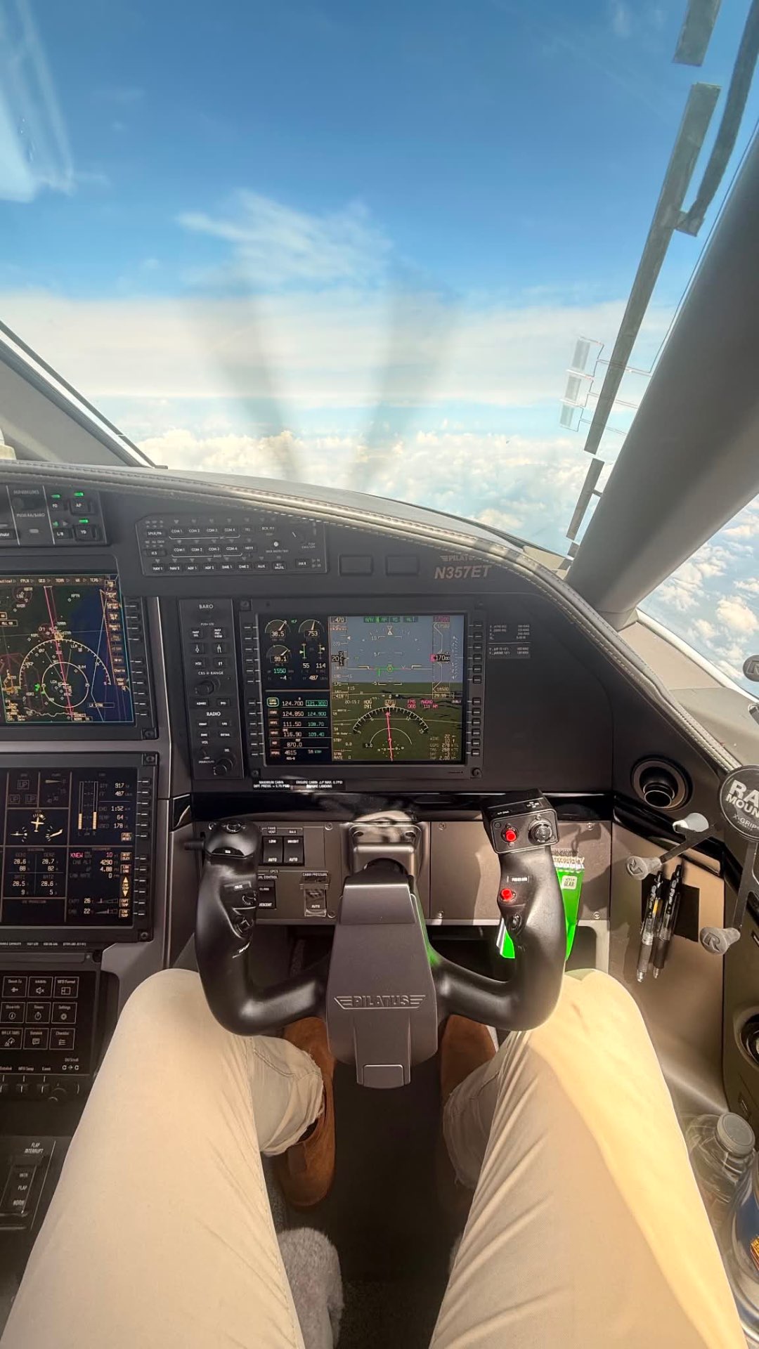 Cockpit view of a Pilatus PC-12 in flight above the clouds